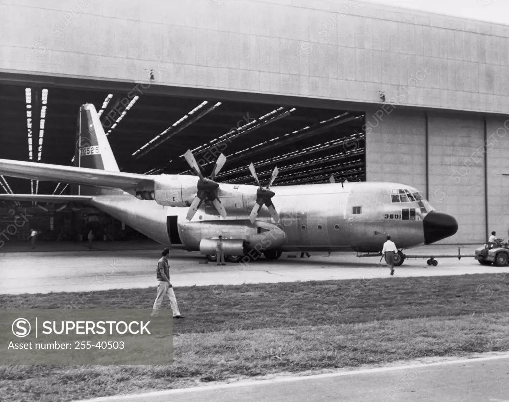 Land vehicle hauling an airplane out of a hanger, C-130B Hercules