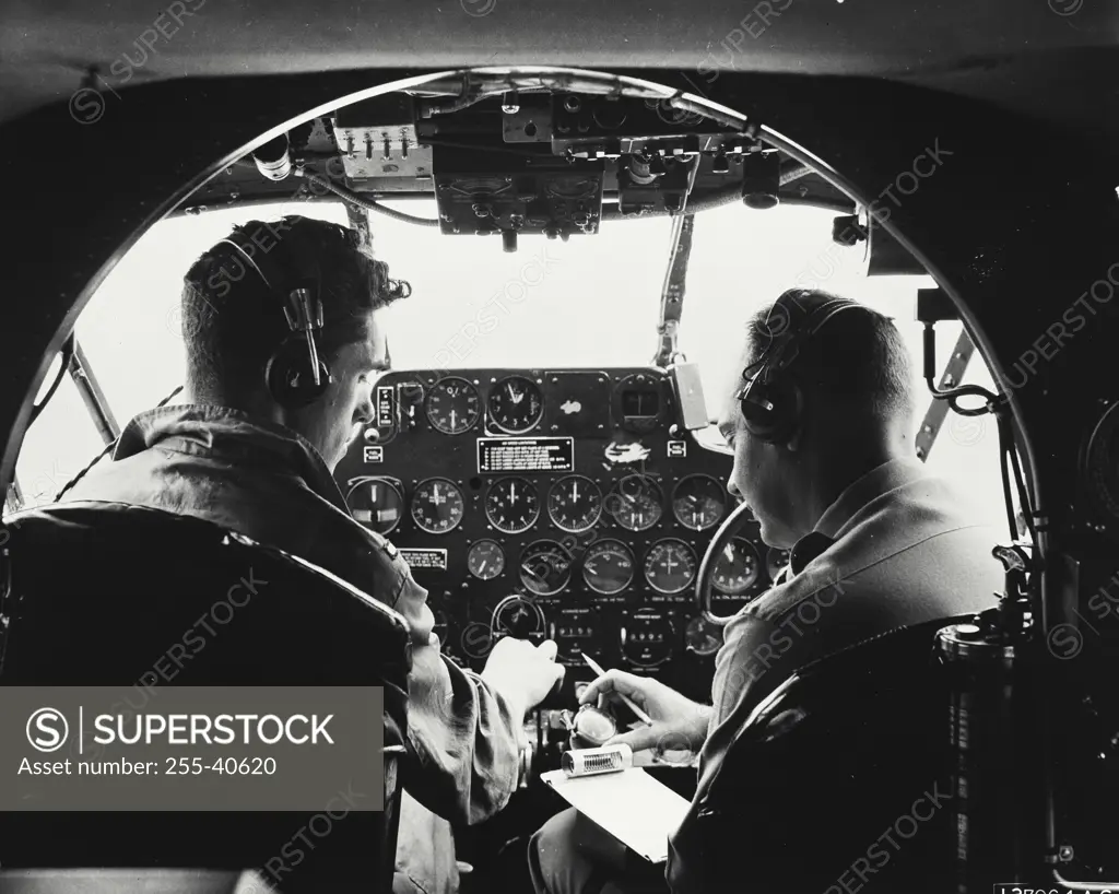 Vintage photograph. Instructor giving student pre flight instructions inside a C-45 plane at Wright-Patterson Air Force Base