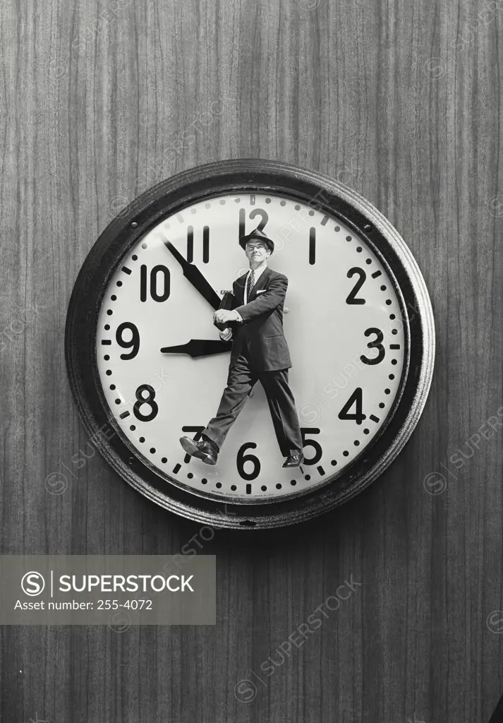 Vintage Photograph. Cutout of man wearing suit walking placed on clock face, Frame 1