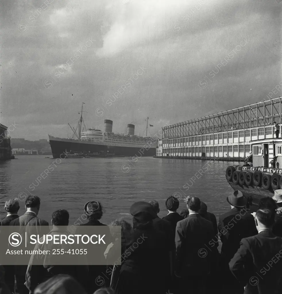 Vintage Photograph. People gathered waiting at dock for Queen Elizabeth ship to arrive in New York City
