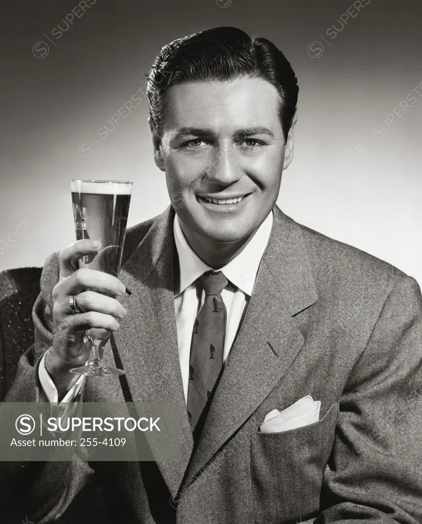 Portrait of mid adult man holding glass of beer