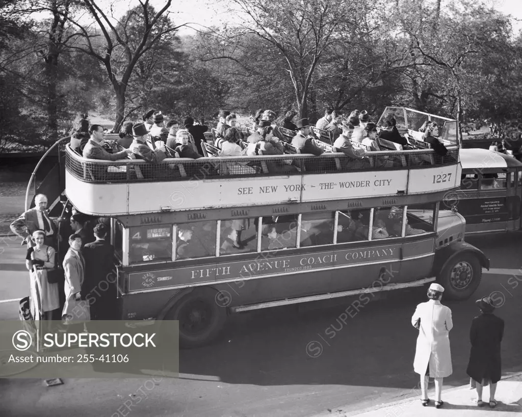 Vintage Photograph. Fifth avenue Coach Company double decker bus packed with tourists parked on side of road.