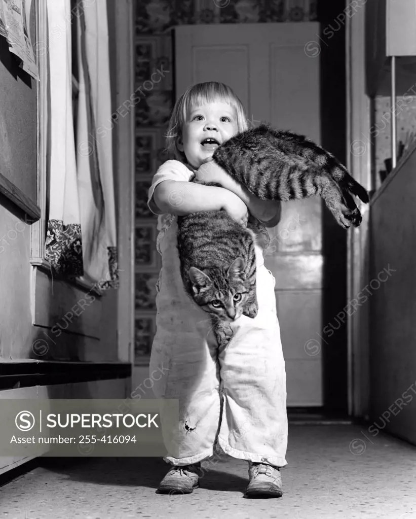 Little boy holding cat