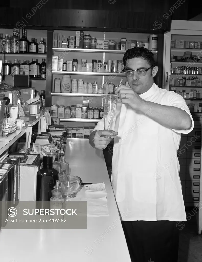 Man preparing medicines in pharmacy