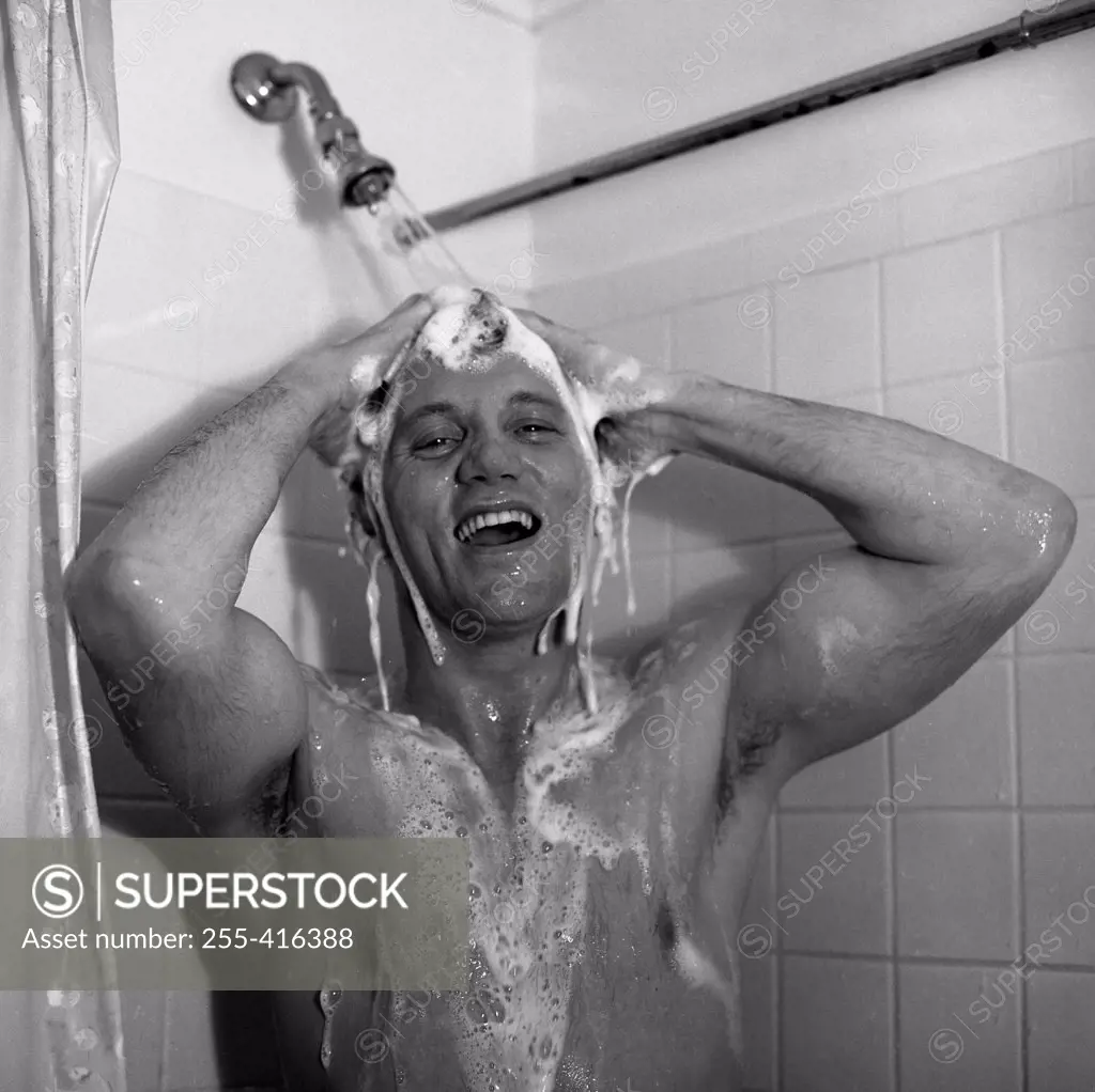 Man taking shower and laughing