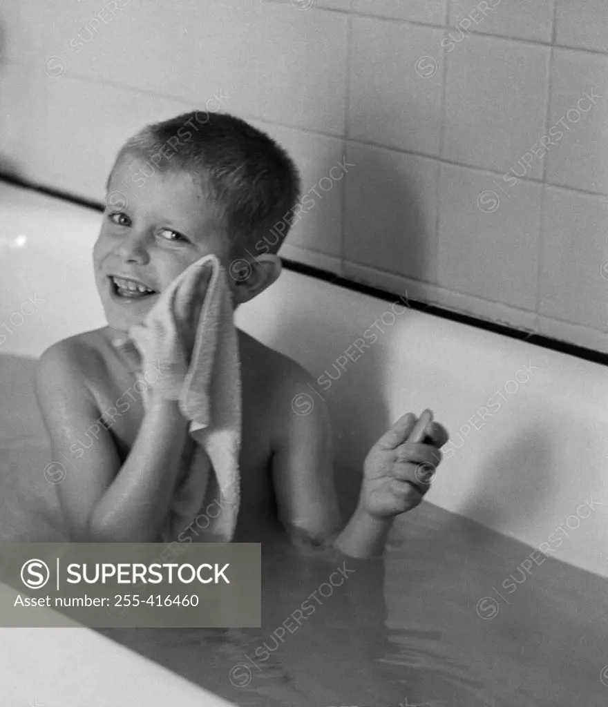 Boy  washing himself in bathtub