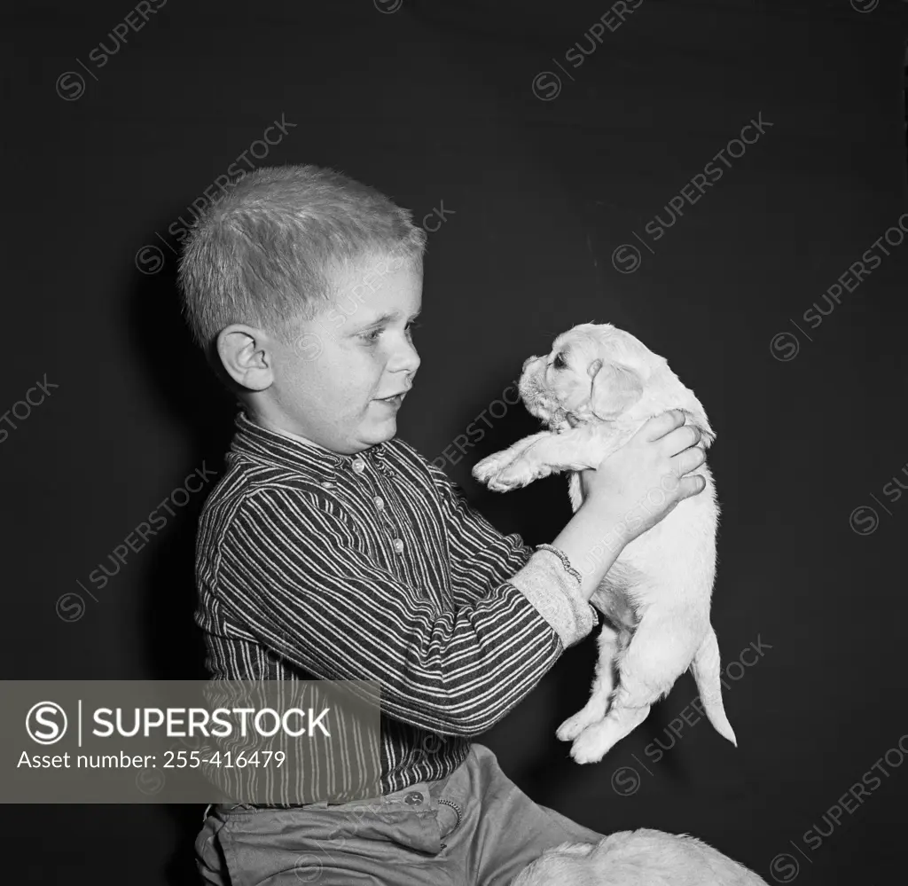 Portrait of boy with puppy