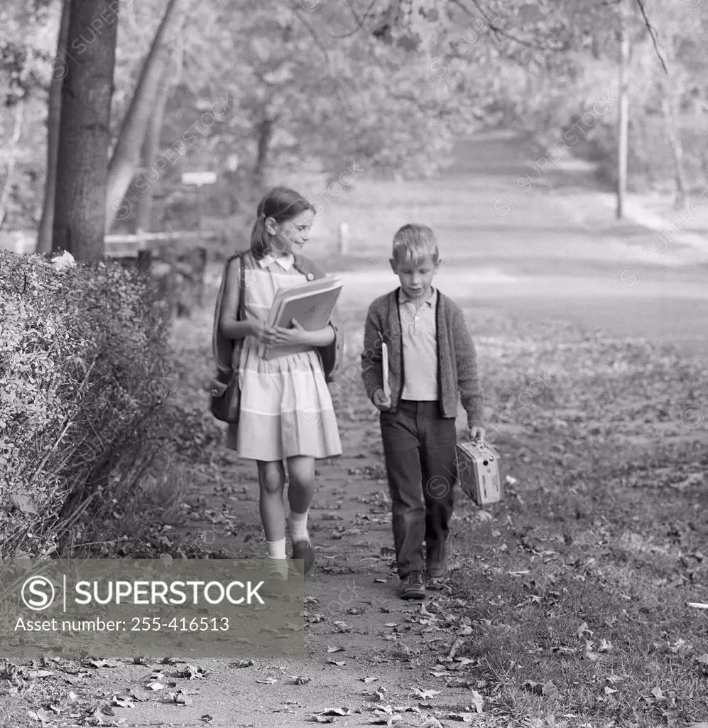 Boy and girl walking to school