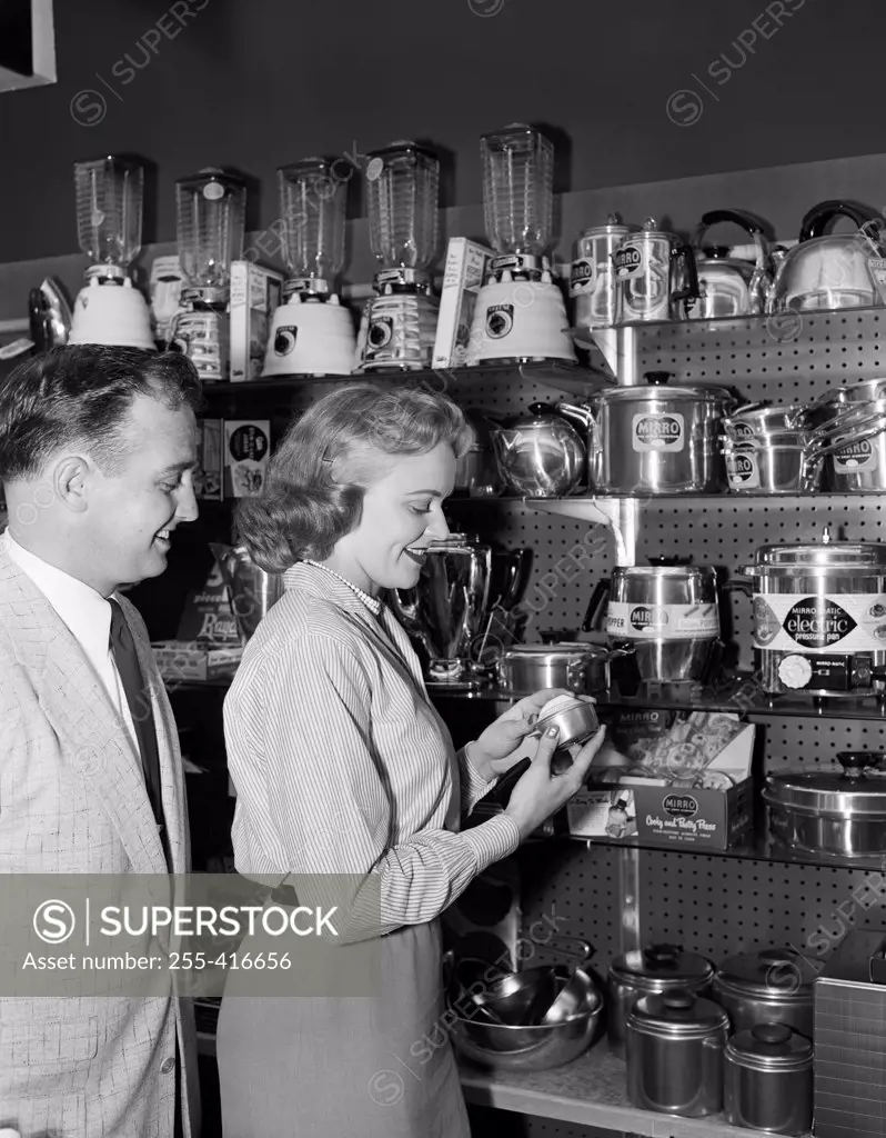 Woman in shop with kitchen utensils