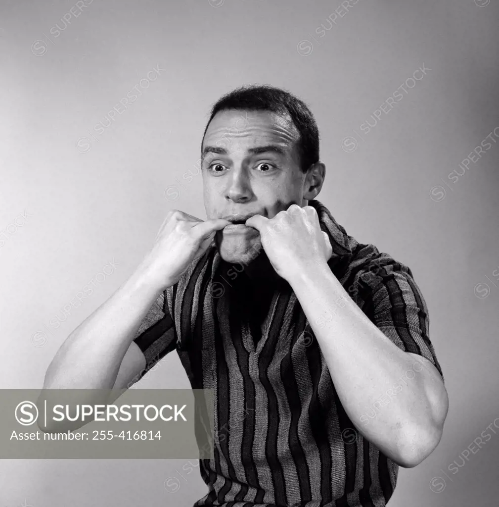 Portrait of man whistling