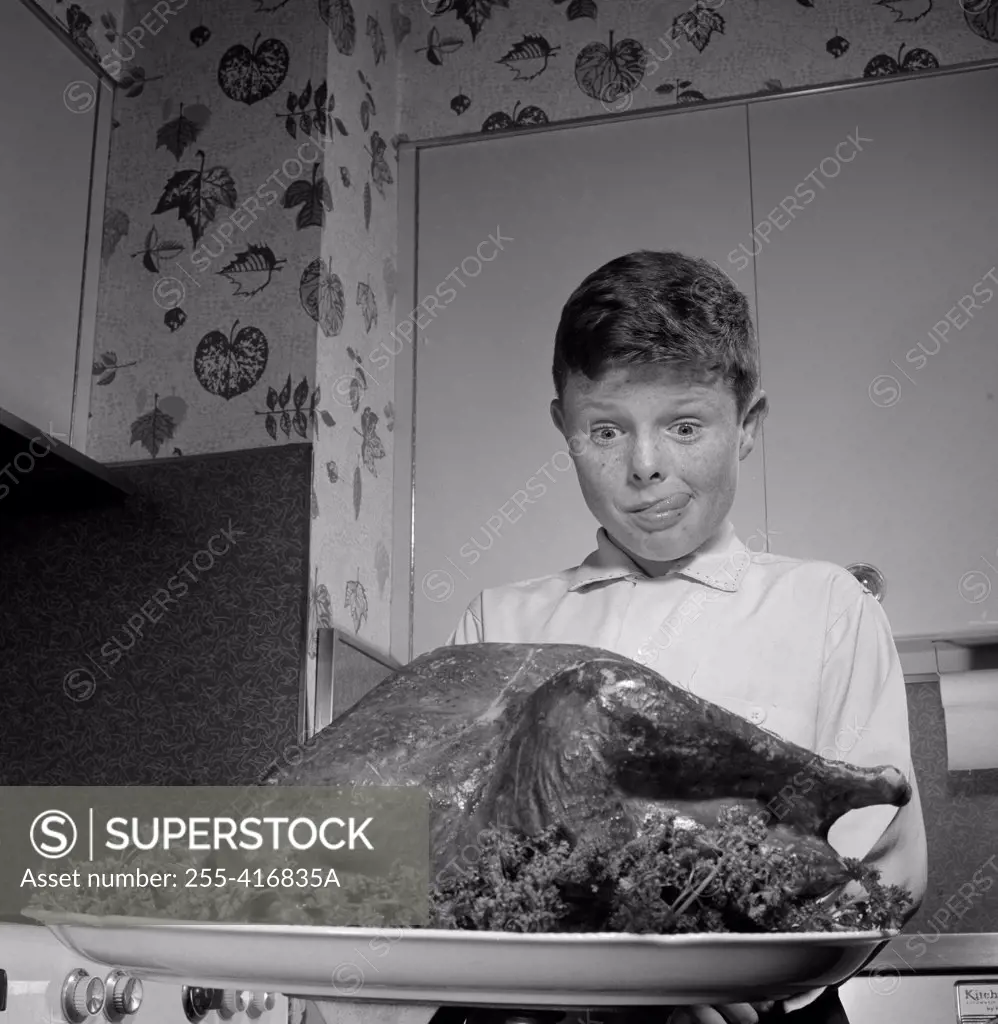 Boy looking at roast turkey