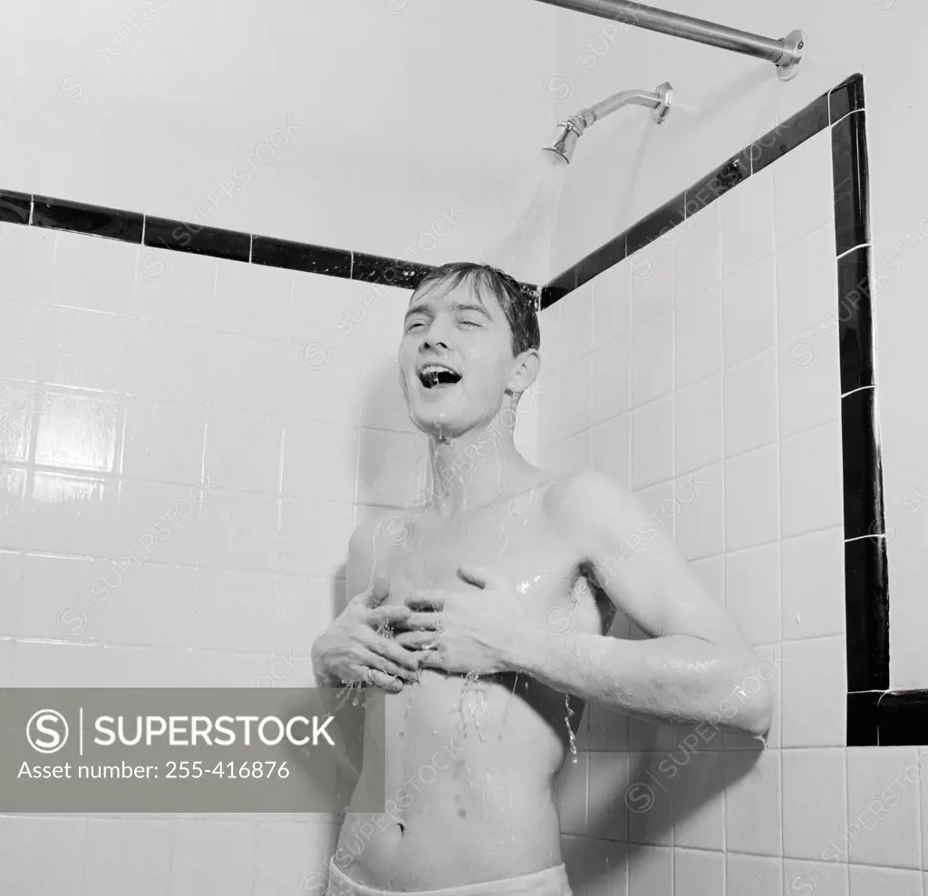 Young man taking shower