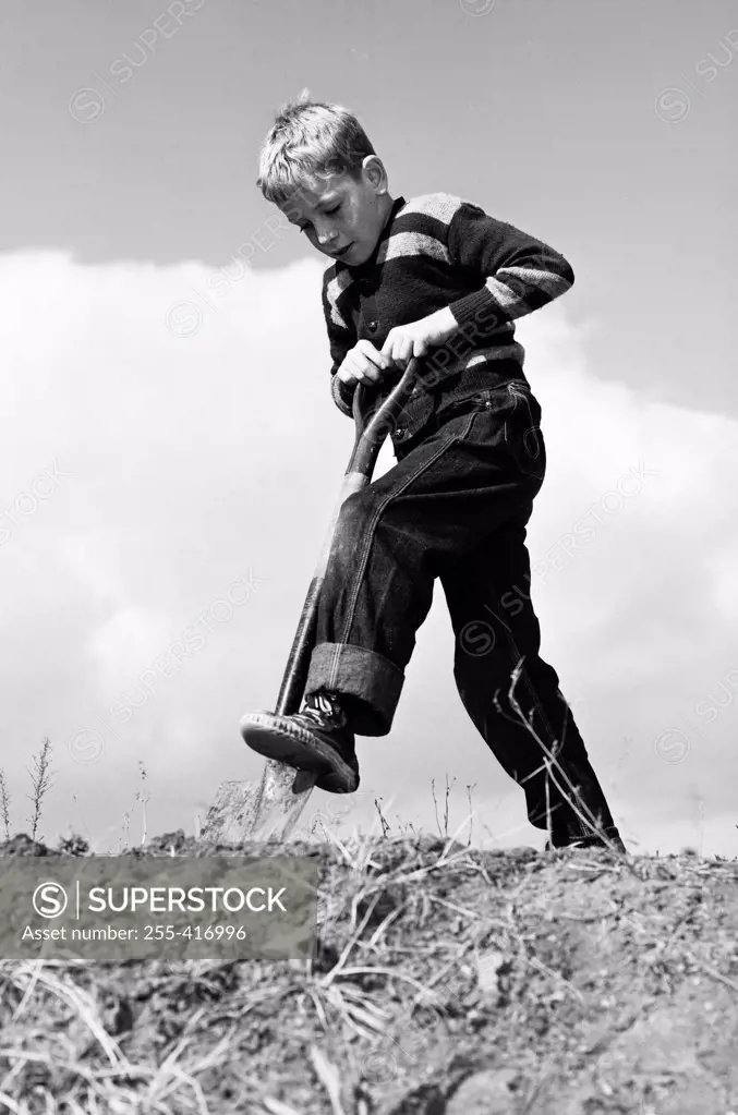 Boy digging with shovel