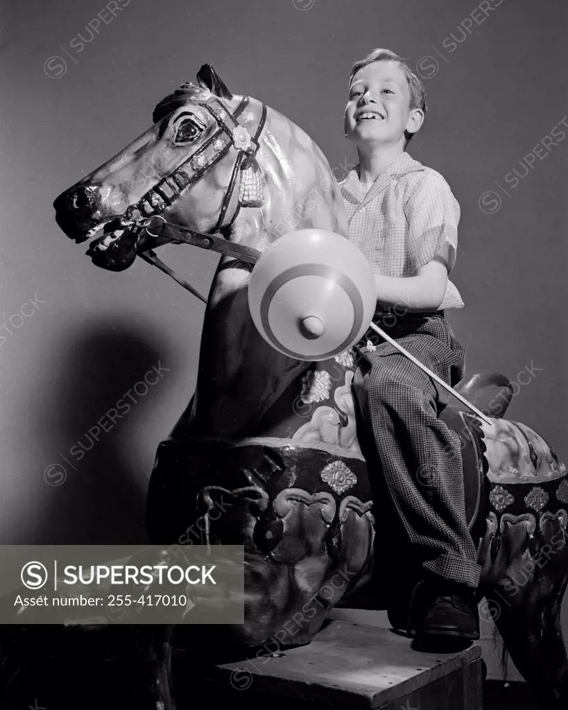 Boy riding on carousel