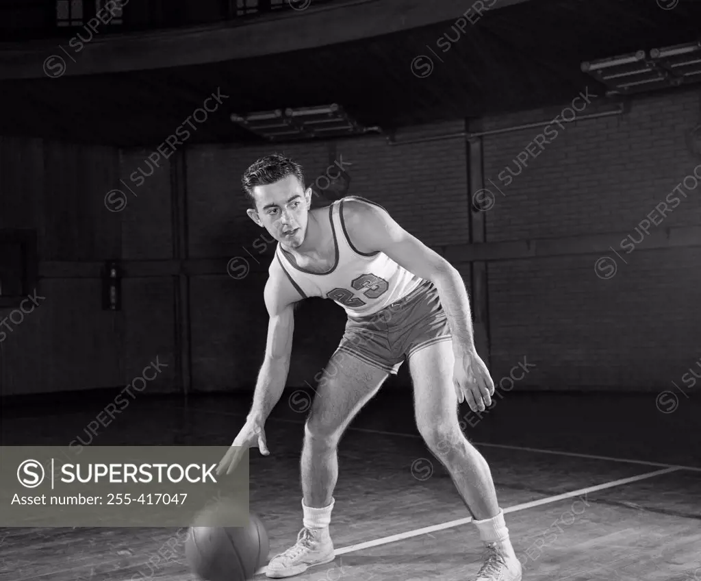 Man playing basketball in gym