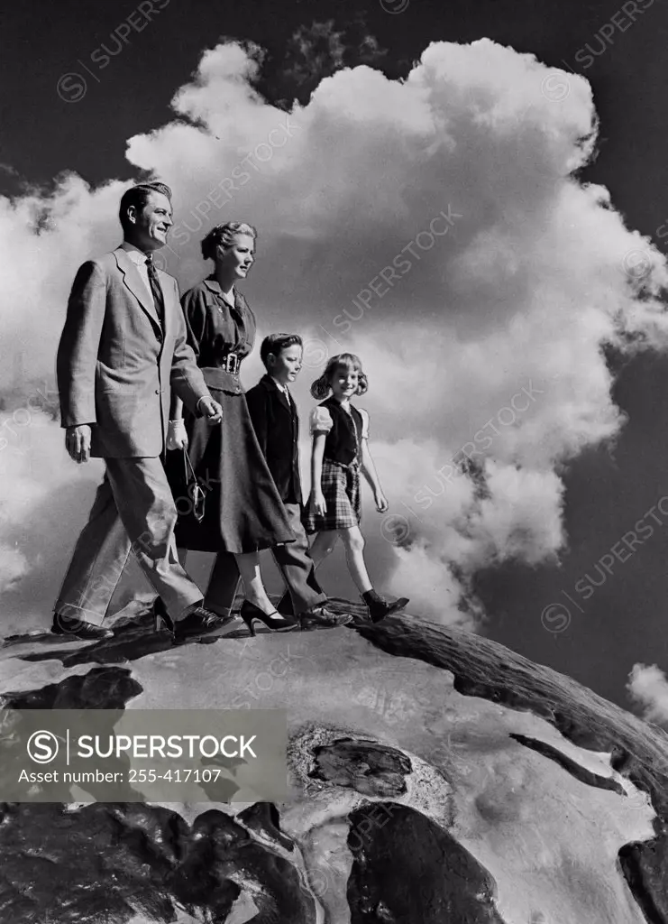 Family with two kids walking in clouds