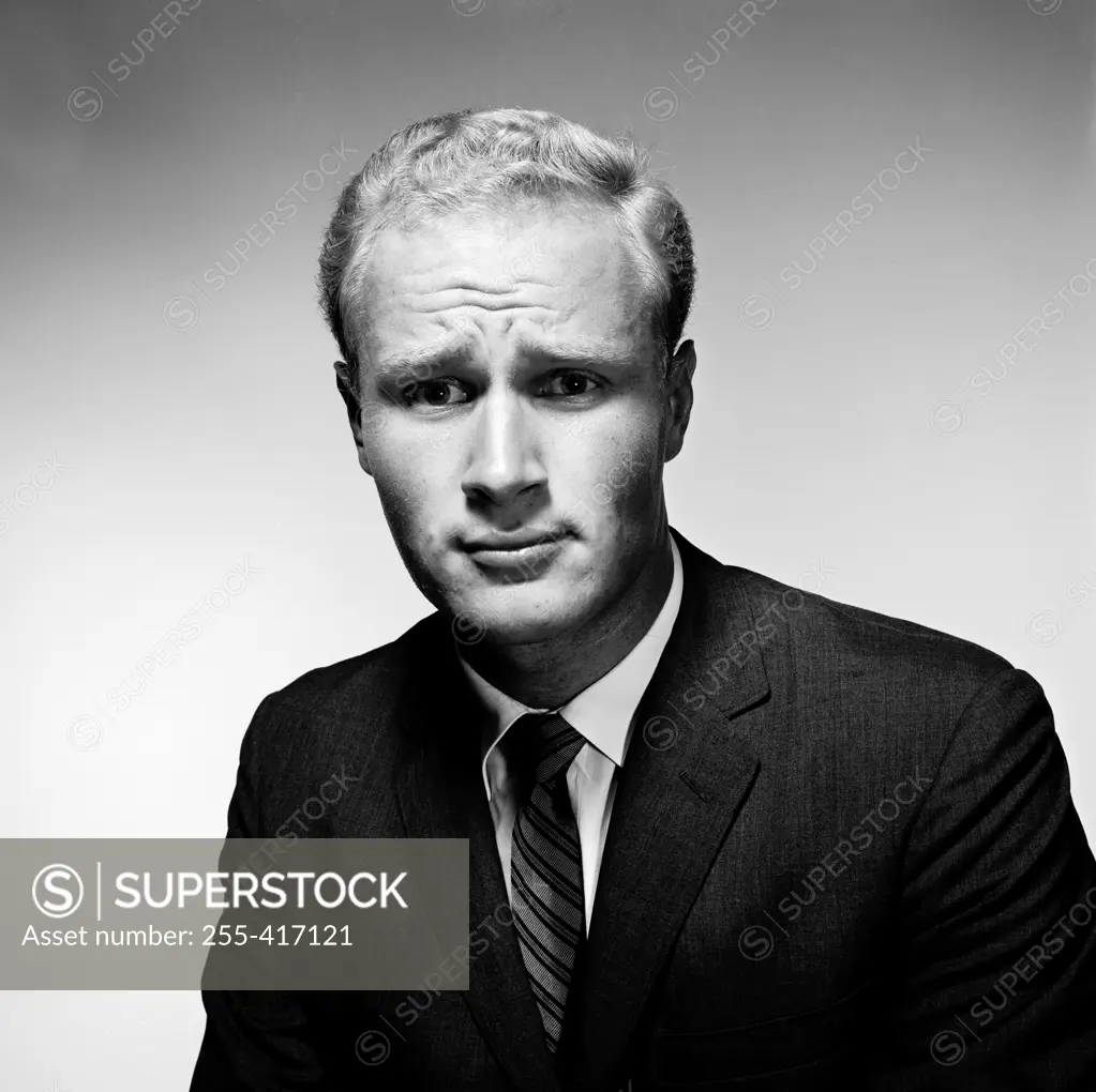 Portrait of troubled young man wearing suit
