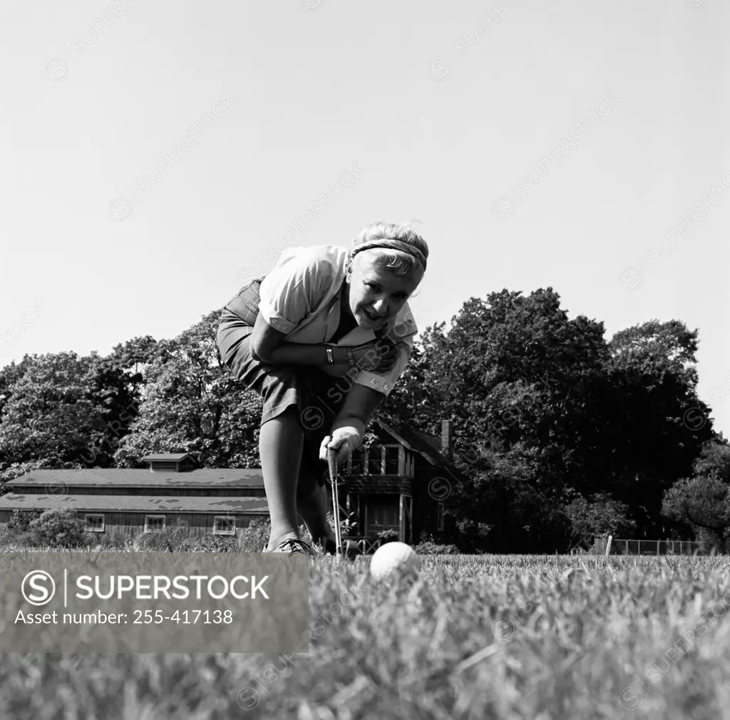 Surface level view of young woman playing golf
