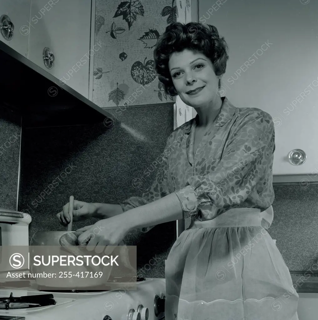Portrait of smiling woman cooking