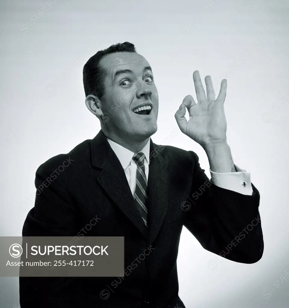 Studio portrait of man showing OK hand sign