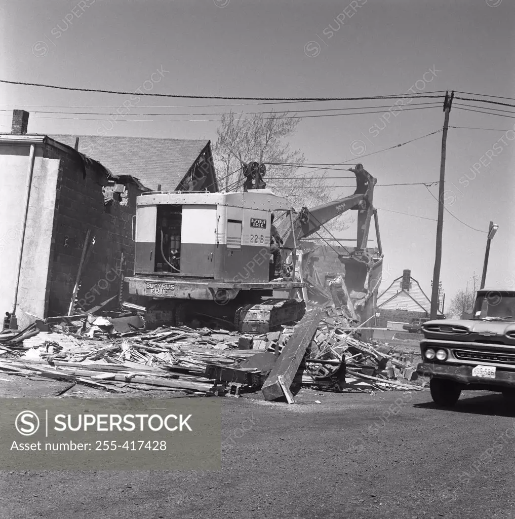 Digger demolishing building