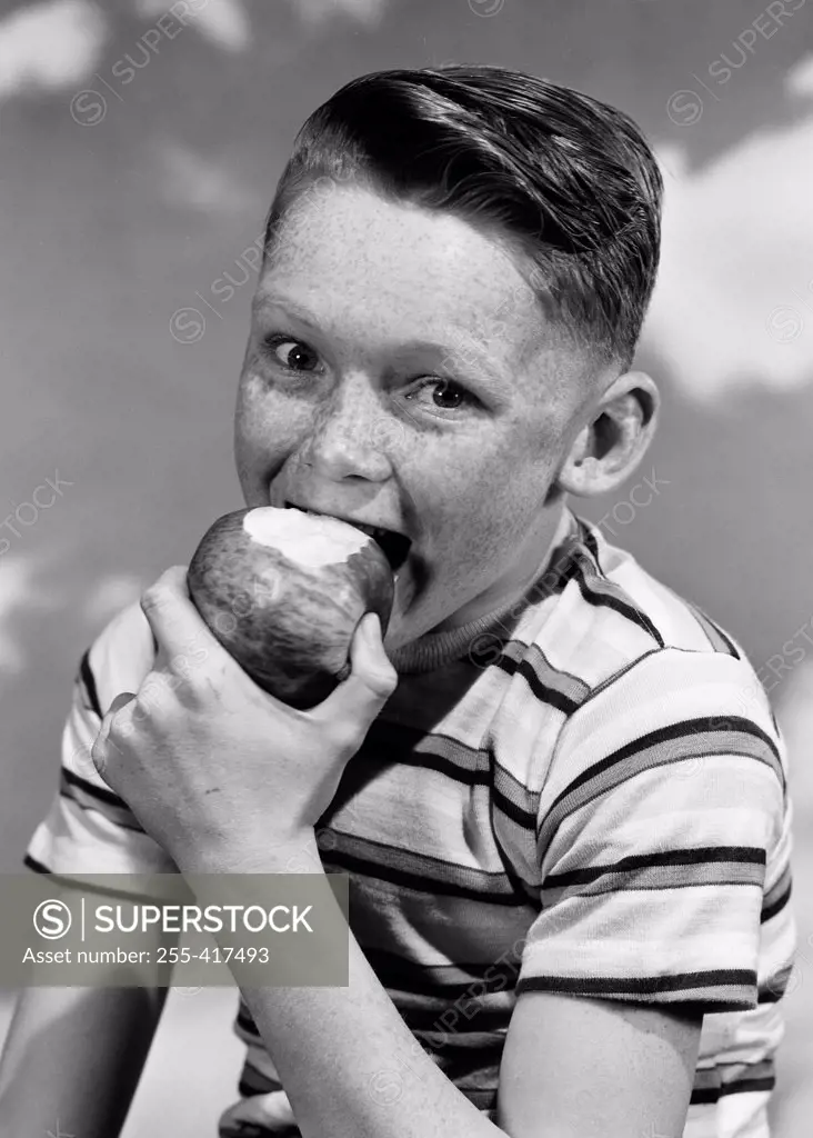Portrait of boy eating apple