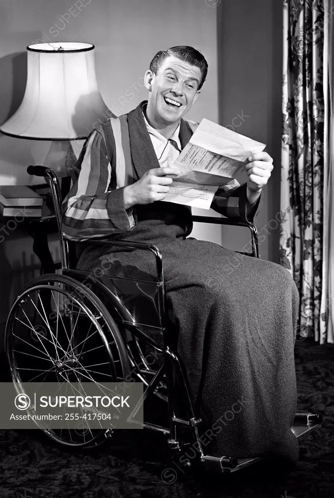 Man in wheelchair reading letter