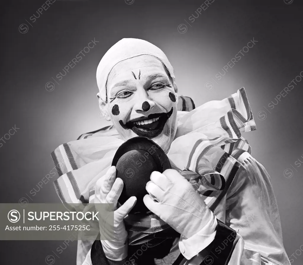 Studio portrait of clown laughing