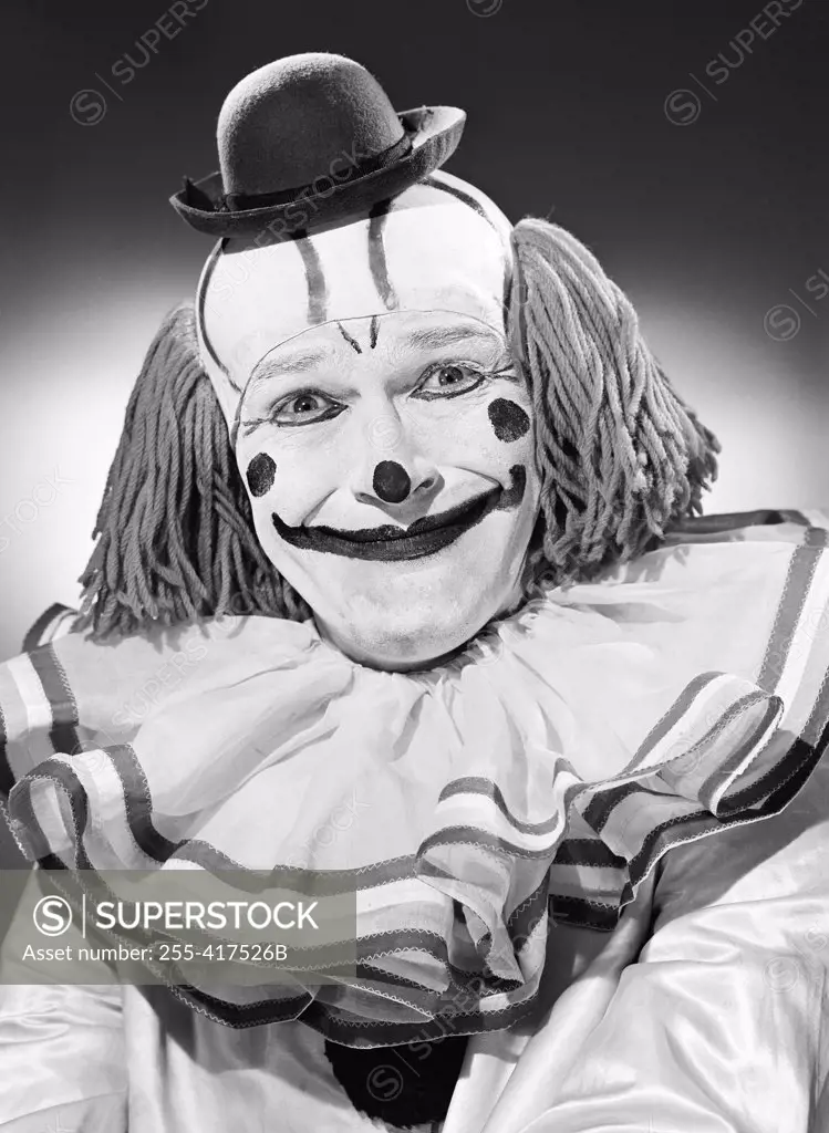 Studio portrait of clown smiling