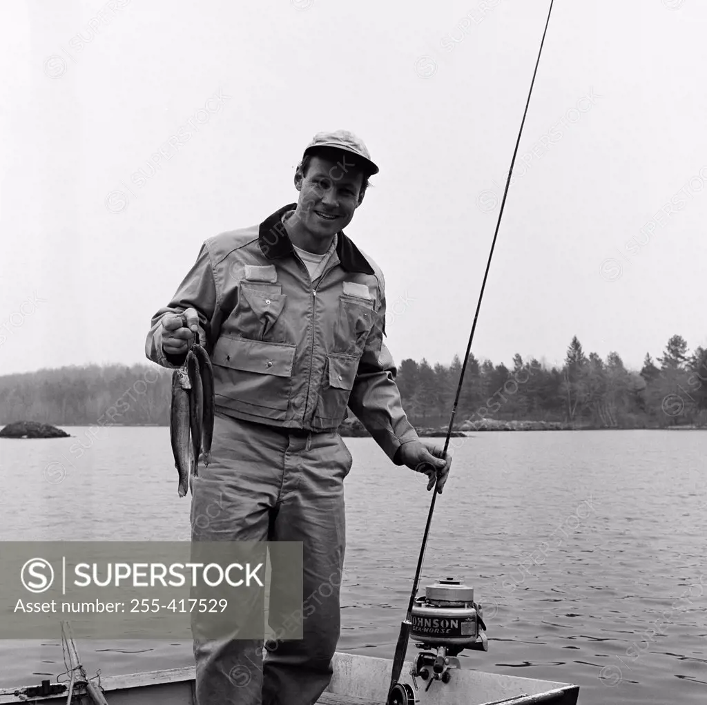 Portrait of man fishing in lake