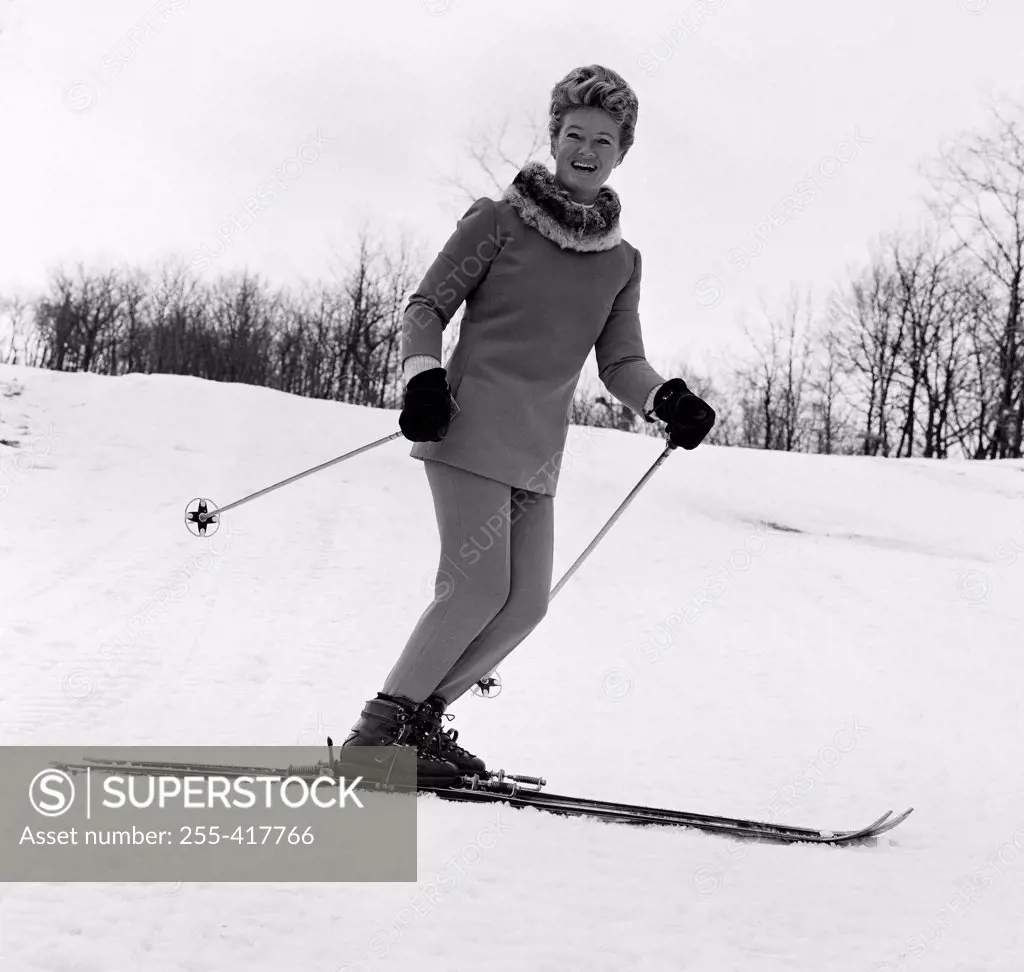 Elegant woman smiling and skiing