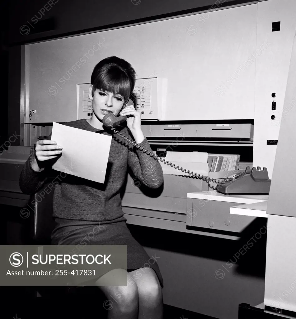 Young woman at office on the phone