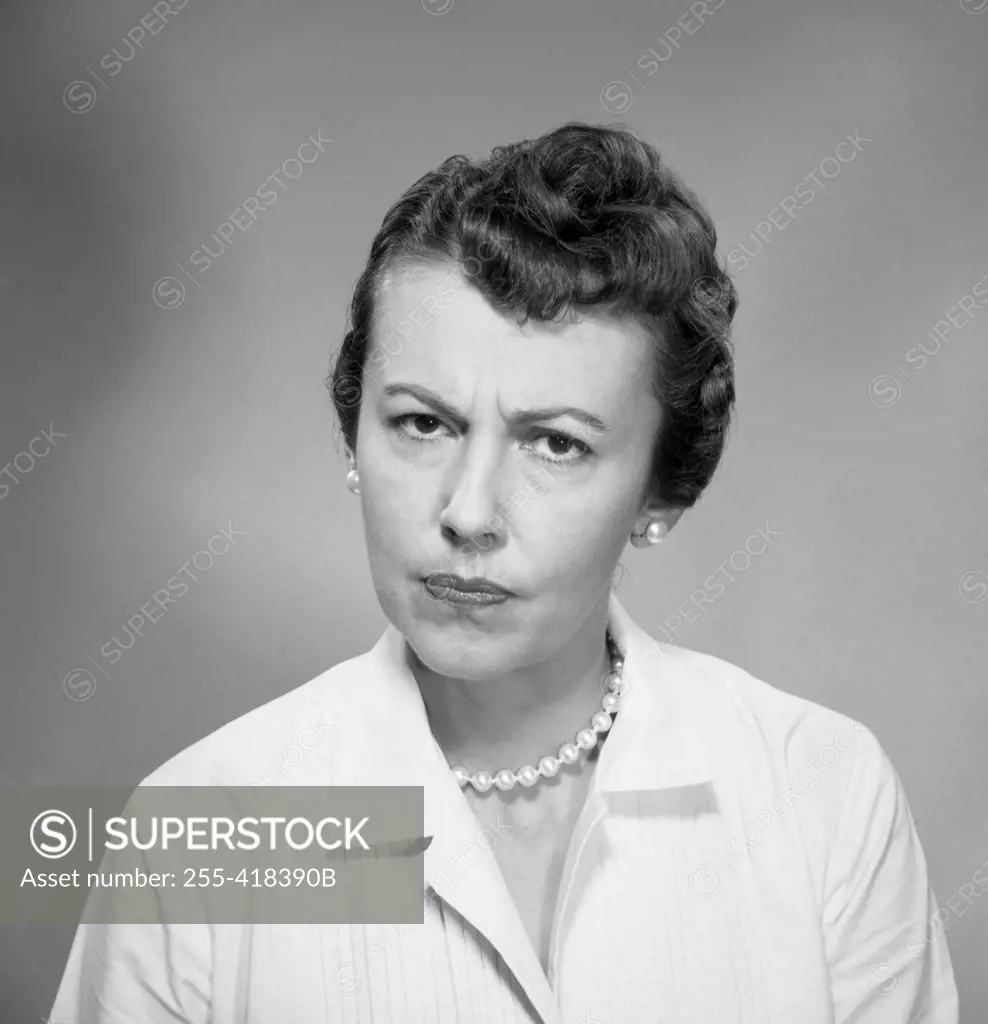 Studio portrait of grumpy woman
