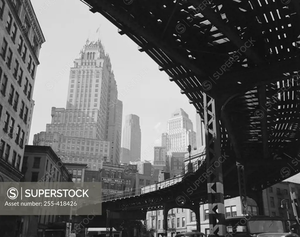 USA, New York State, New York City, Manhattan, Skyscrapers and elevated railroad track, low angle view