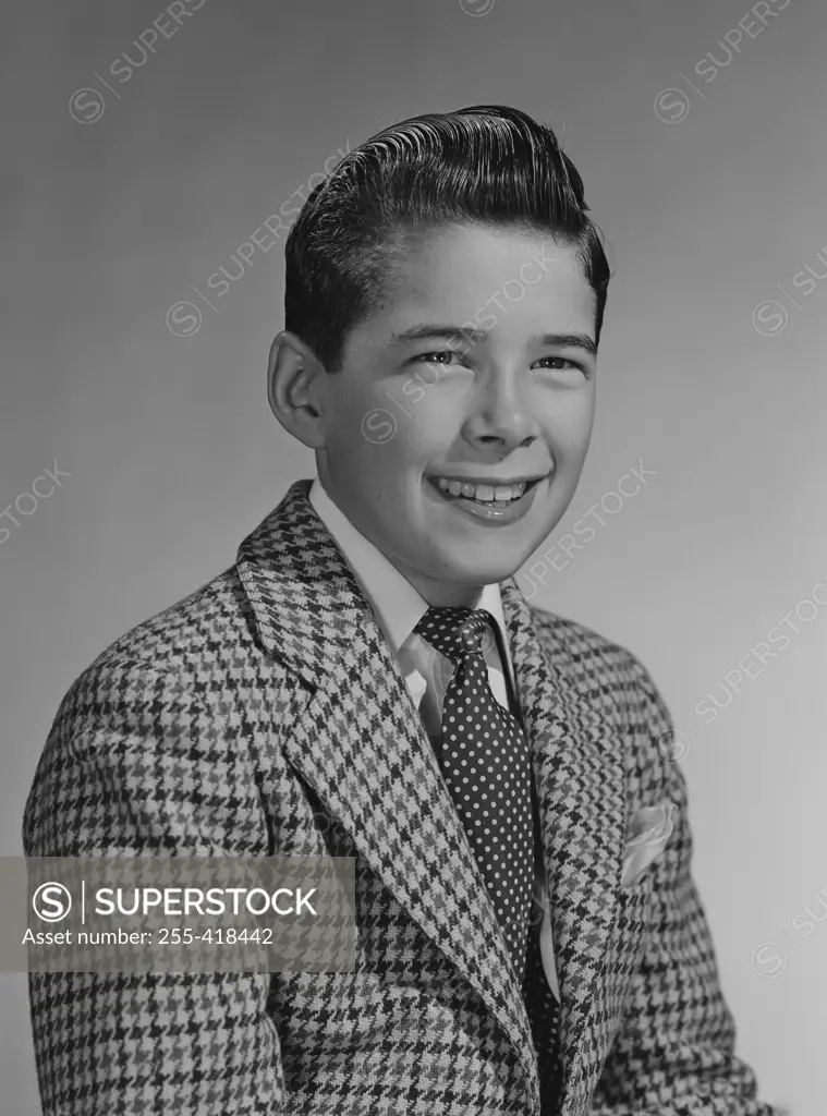 Portrait of boy in pepita jacket and tie