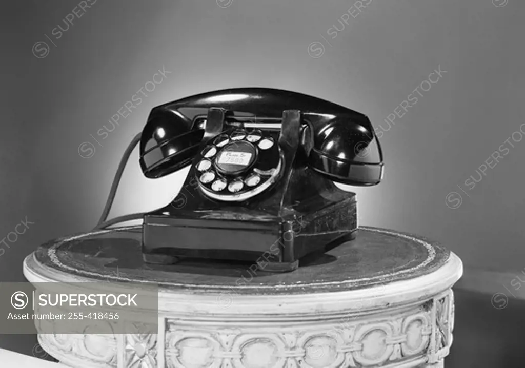 Old fashioned phone on carved post