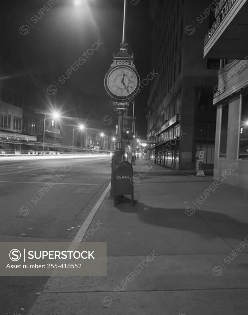 Night view with street clock and mailbox