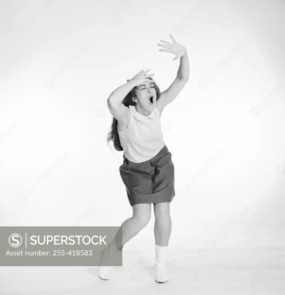 Young woman dancing and singing
