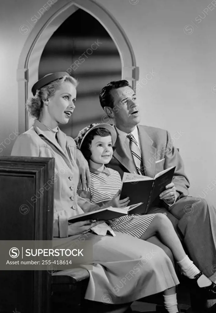 Girl with parents in church
