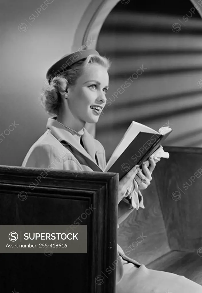 Woman reading bible in church