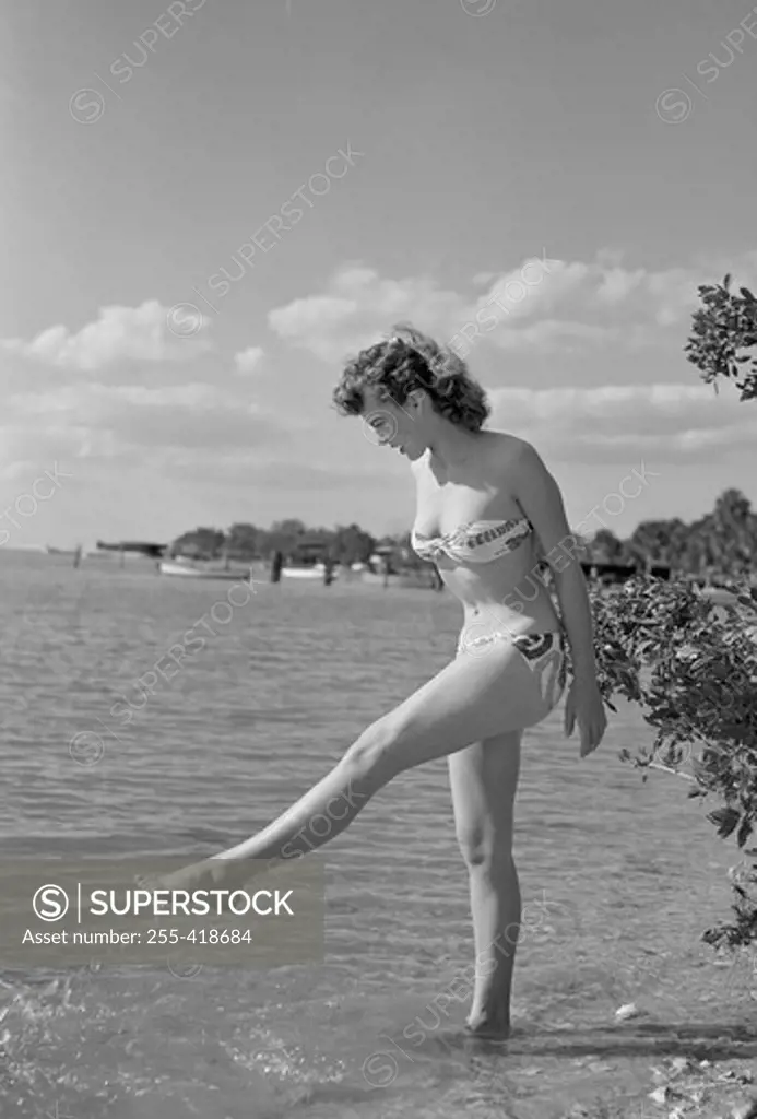 Young woman walking over lake