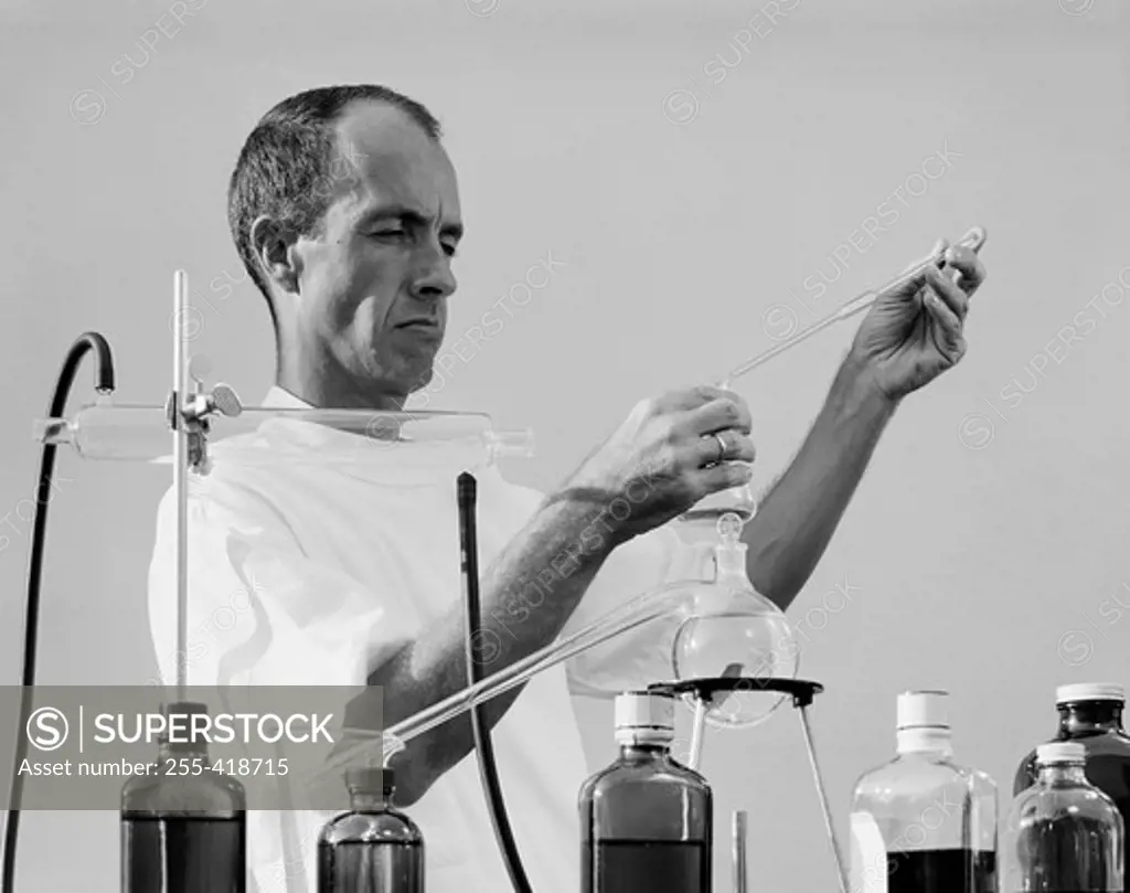 Scientist mixing chemicals in laboratory
