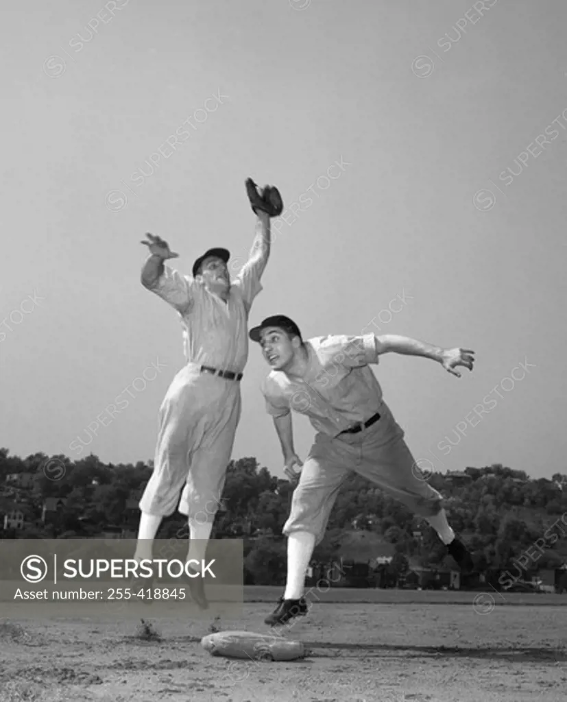 Two baseball players in field
