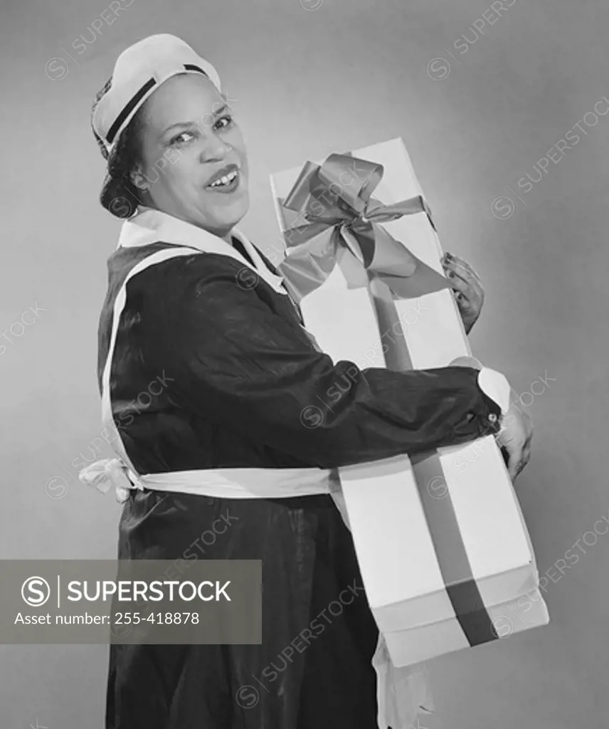 Maid carrying box wrapped with ribbon