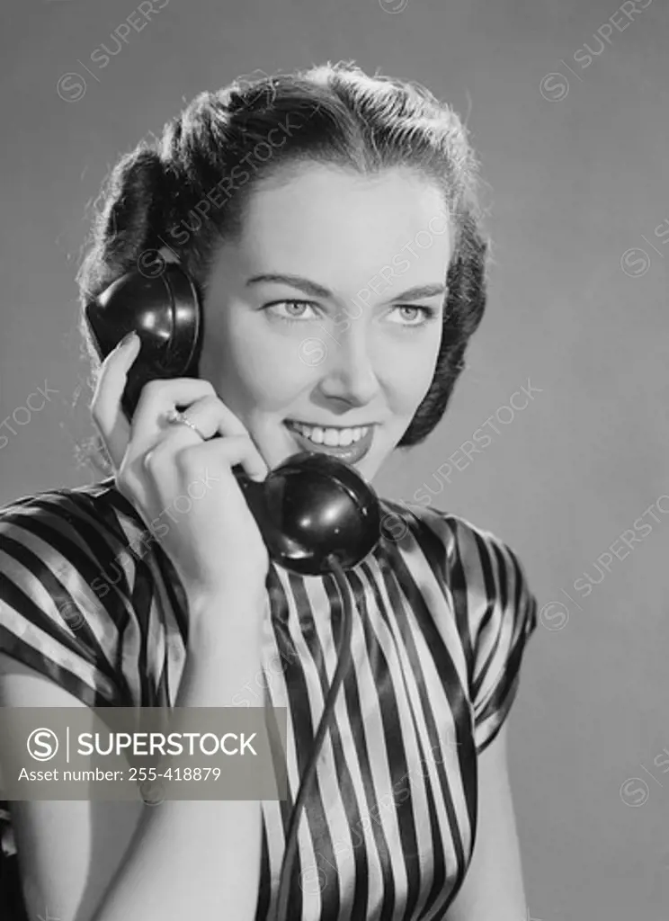 Attractive young woman talking on the phone