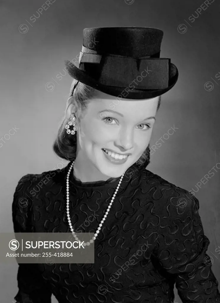 Portrait of elegant young woman wearing bowler hat