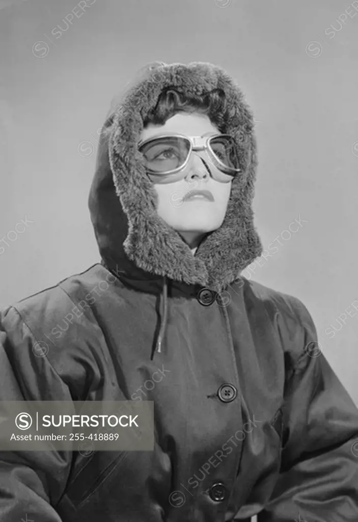 Portrait of young woman wearing sunglasses and anorak