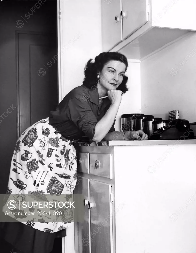 Woman preparing to do list in kitchen