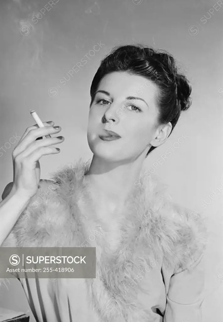 Attractive young woman smoking cigarette