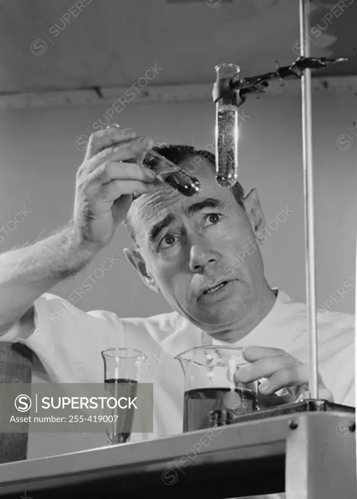 Scientist conducting experiment with test tubes